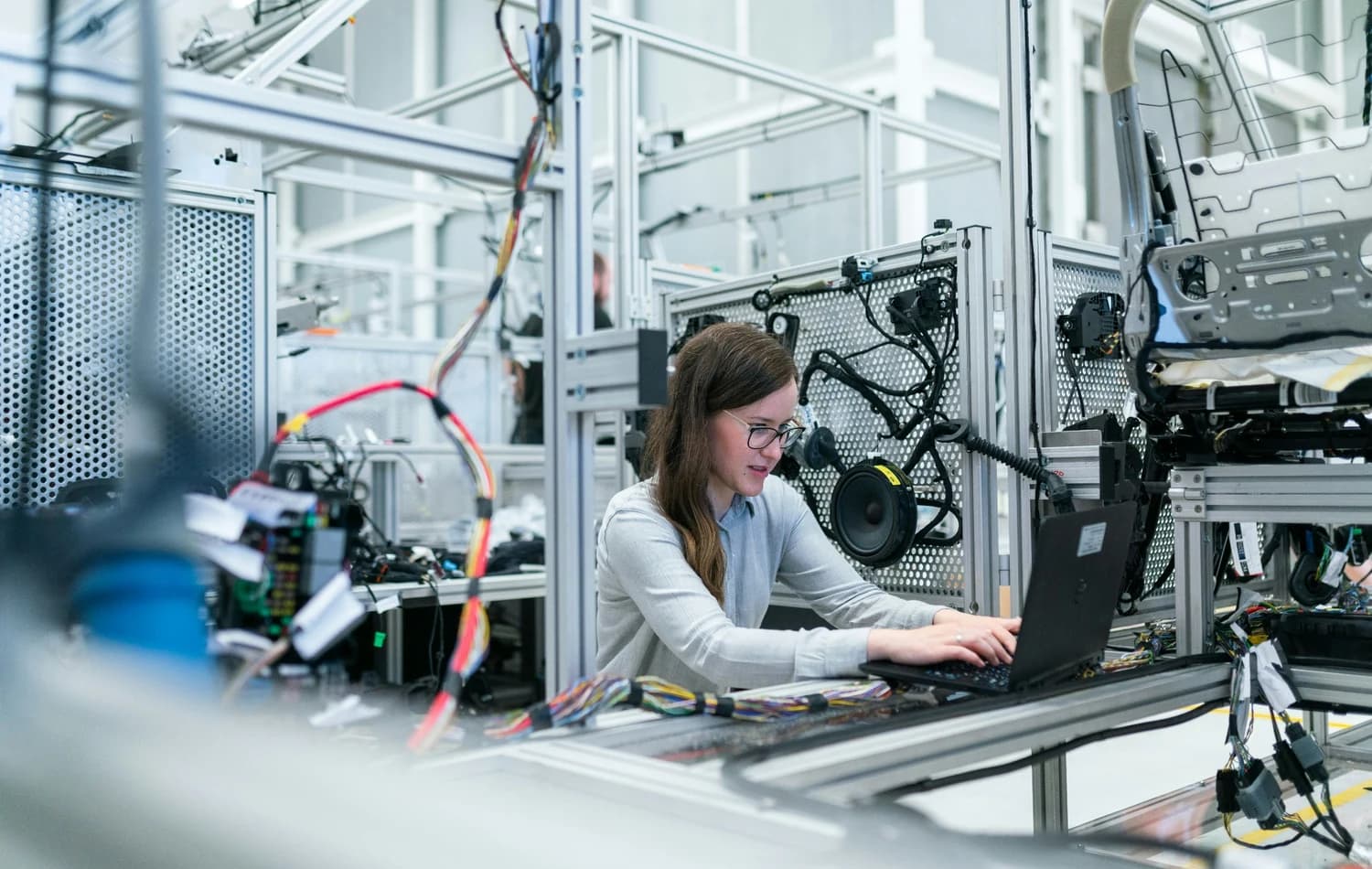 Engineer working on a wiring harness test rig in a lab setting